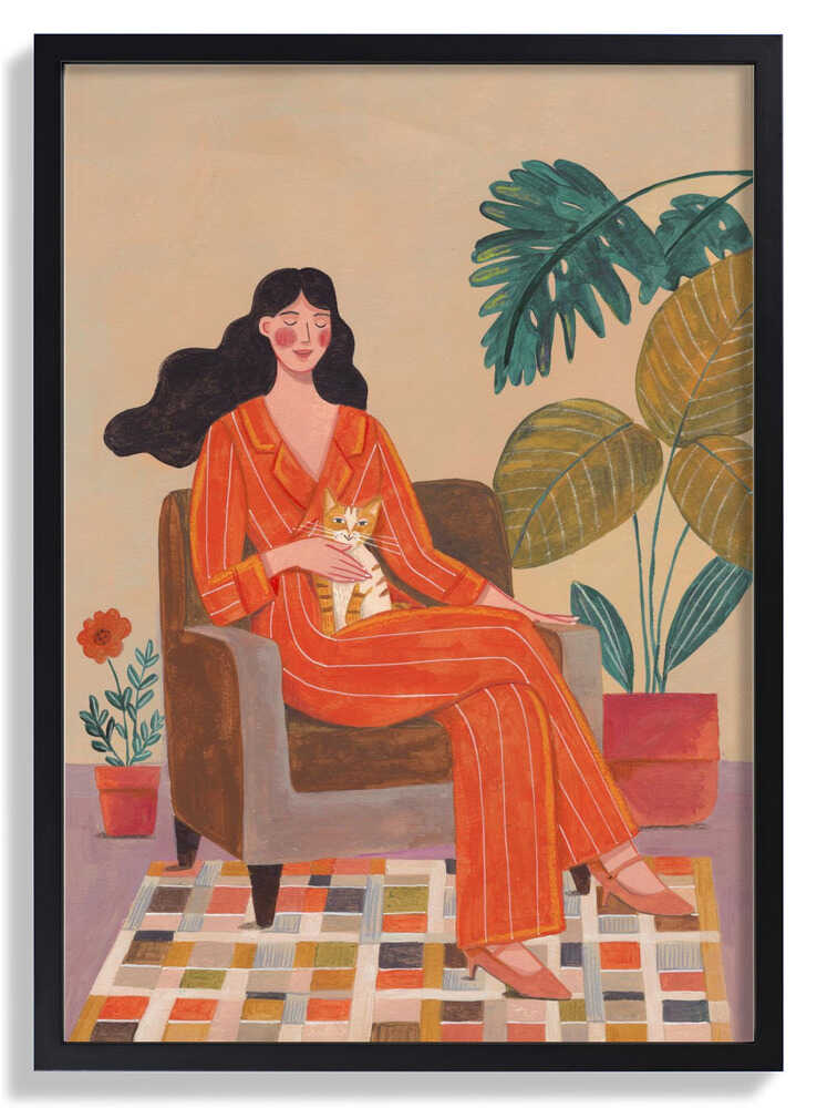 Woman with cat in living room with warm earth tones by Caroline Bonne Müller
