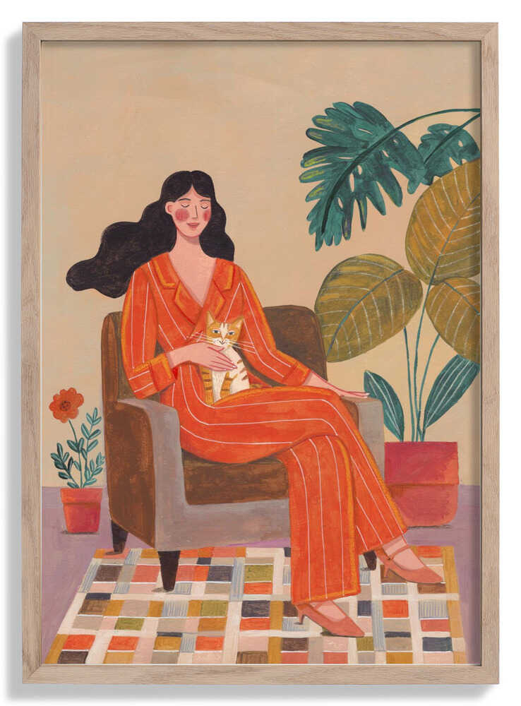 Woman with cat in living room with warm earth tones by Caroline Bonne Müller