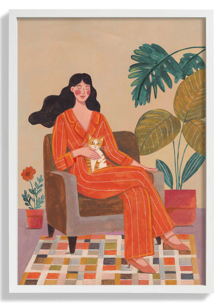 Woman with cat in living room with warm earth tones by Caroline Bonne Müller